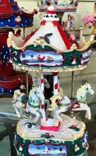 Carrusel musical con caballos: Carrusel musical con caballos blancos y detalles navideños.